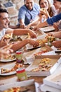 Having a great time with good food and amazing friends. a group of friends enjoying pizza together. Royalty Free Stock Photo