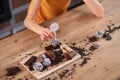 Distressed curly-haired woman lying on table surface and desiring sweets Royalty Free Stock Photo