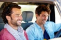 Having a laugh with a friend. Two young male friends sharing a joke while driving. Royalty Free Stock Photo