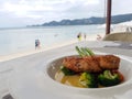 Having lunch in a restaurant on the beach.