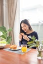 Having meal concept a smiling woman appreciating her favorite desserts on the table in a dinning room