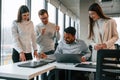 Having the meeting. Four people are working in the office together