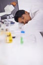 Having a midday power nap. A beautiful young scientist napping on her desk in her lab. Royalty Free Stock Photo