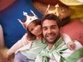 Having so much fun. A cute little girl dressed up as a princess while playing at home with her dad. Royalty Free Stock Photo