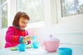 Having a parTEA for one. an adorable little girl having a tea party at home. Royalty Free Stock Photo