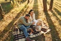 Having picnik. Happy family of father, mother and little daughter is in the forest Royalty Free Stock Photo