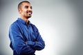 Having a pleasing personality is always an asset. a young businessman posing against a grey background.