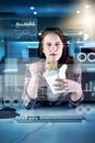 Having a quick snack before climbing back into work. Portrait of a focused young female programmer working on a computer Royalty Free Stock Photo