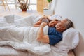 Couple of businessmen having rest while lying in bed in the morning