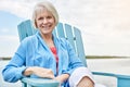 Having the rest of my life. Portrait of a happy senior woman relaxing on a chair outside. Royalty Free Stock Photo