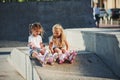 Having a rest. On the ramp for extreme sports. Two little girls with roller skates outdoors have fun Royalty Free Stock Photo