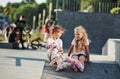 Having a rest. On the ramp for extreme sports. Two little girls with roller skates outdoors have fun Royalty Free Stock Photo