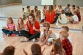 Having some fun after choreography class. Young female dance teacher with group of happy children clapping and playing Royalty Free Stock Photo