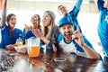 Having some light-hearted fun with friends. people watching their favorite team live in a sports bar. Royalty Free Stock Photo