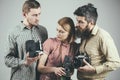 Having some problems. Group of photographers with retro cameras. Retro style woman and men hold analog photo cameras Royalty Free Stock Photo