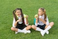 Having taste of lemon. Little girl point at sour apple fruit. Fruit acid. Small children eat fruit on green grass