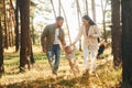 Having a walk. Happy family of father, mother and little daughter is in the forest Royalty Free Stock Photo