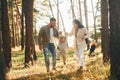 Having a walk. Happy family of father, mother and little daughter is in the forest Royalty Free Stock Photo