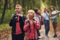 Having a walk. Kids in green forest at summer daytime together Royalty Free Stock Photo