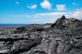 Hawaii hardened lava flow against a blue sky with the ocean in the distance Royalty Free Stock Photo