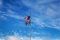 Hawaiian and American flags on a blue cloudy sky background Royalty Free Stock Photo