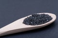 Hawaiian Black Lava Sea Salt in handmade wooden spoon on dark