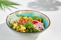 Hawaiian cuisine - Poke bowl with salmon, avocado, edamame and vegetables. Pokebowl in ceramic dish on white background with Royalty Free Stock Photo