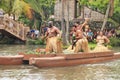 Oahu, Hawaii - 4/26/2018 - Hawaiian dancers performing while riding a canoe float at the Polynesian Cultural Center in Hawaii