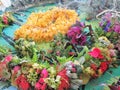 Hawaiian flower leis on display at an outdoor festival