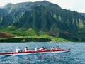 Hawaiian Outrigger Canoe racing Passing the Cathedrals formation along Na Pali Coast in Hawaii Royalty Free Stock Photo