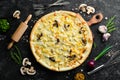 Hawaiian pizza with chicken, pineapple and mushrooms on the table. Rustic style.