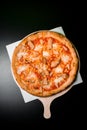 Hawaiian pizza with cream sauce, mozzarella cheese, corn, chicken and pineapple isolated over black background. Royalty Free Stock Photo