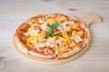 Hawaiian pizza with pineapple and ham on wooden table. Royalty Free Stock Photo