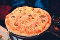 Hawaiian Pizza on a wooden tray on the table. Royalty Free Stock Photo