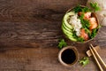 Hawaiian poke coconut bowl with grilled salmon fish, rice and avocado. Healthy food Royalty Free Stock Photo