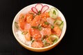 Hawaiian poke with salmon and sesame seeds, boiled rice, fresh c