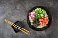 Hawaiian salmon fish poke bowl with rice, radish,cucumber, tomato, sesame seeds and seaweeds Royalty Free Stock Photo