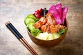 Hawaiian salmon poke bowl with seaweed, watermelon radish, cucumber, pineapple and sesame seeds. Copy space