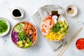 Hawaiian salmon and shrimp poke bowls with seaweed, avocado, mango, pickled ginger, sesame seeds. Royalty Free Stock Photo