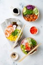 Hawaiian salmon, tuna and shrimp poke bowls with seaweed, avocado, mango, pickled ginger, sesame seeds. Royalty Free Stock Photo