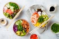 Hawaiian salmon, tuna and shrimp poke bowls with seaweed, avocado, mango, pickled ginger, sesame seeds. Royalty Free Stock Photo