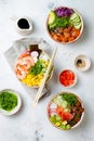 Hawaiian salmon, tuna and shrimp poke bowls with seaweed, avocado, mango, pickled ginger, sesame seeds. Royalty Free Stock Photo