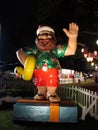 Hawaiian Santa Figures holds rubber ducky as he waves