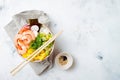 Hawaiian shrimp poke bowl with seaweed, avocado, mango, radish, sesame seeds.