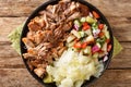 Hawaiian Slow cooked Kalua pork served with cabbage and salad close-up on a plate. horizontall top view