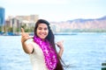 Hawaiian teen with lei making hang loose sign, Waikiki, Honolulu Royalty Free Stock Photo
