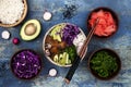 Hawaiian tuna poke bowl with seaweed, avocado, red cabbage slaw, radishes and black sesame seeds.