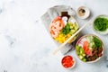 Hawaiian tuna and shrimp poke bowls with seaweed, avocado, mango, pickled ginger, sesame seeds. Royalty Free Stock Photo