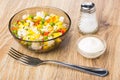 Hawaiian vegetable mix in bowl, salt, bowl with mayonnaise, fork