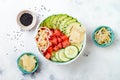 Hawaiian watermelon poke bowl with avocado, cucumber, mung bean sprouts and pickled ginger. Top view, overhead